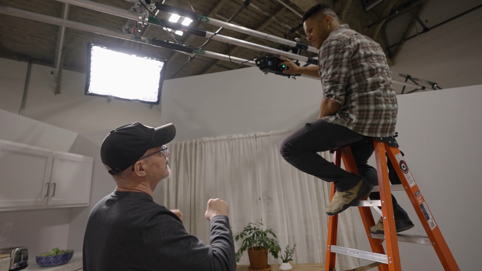 Crew collaborating on camera and lighting during the Donatos production