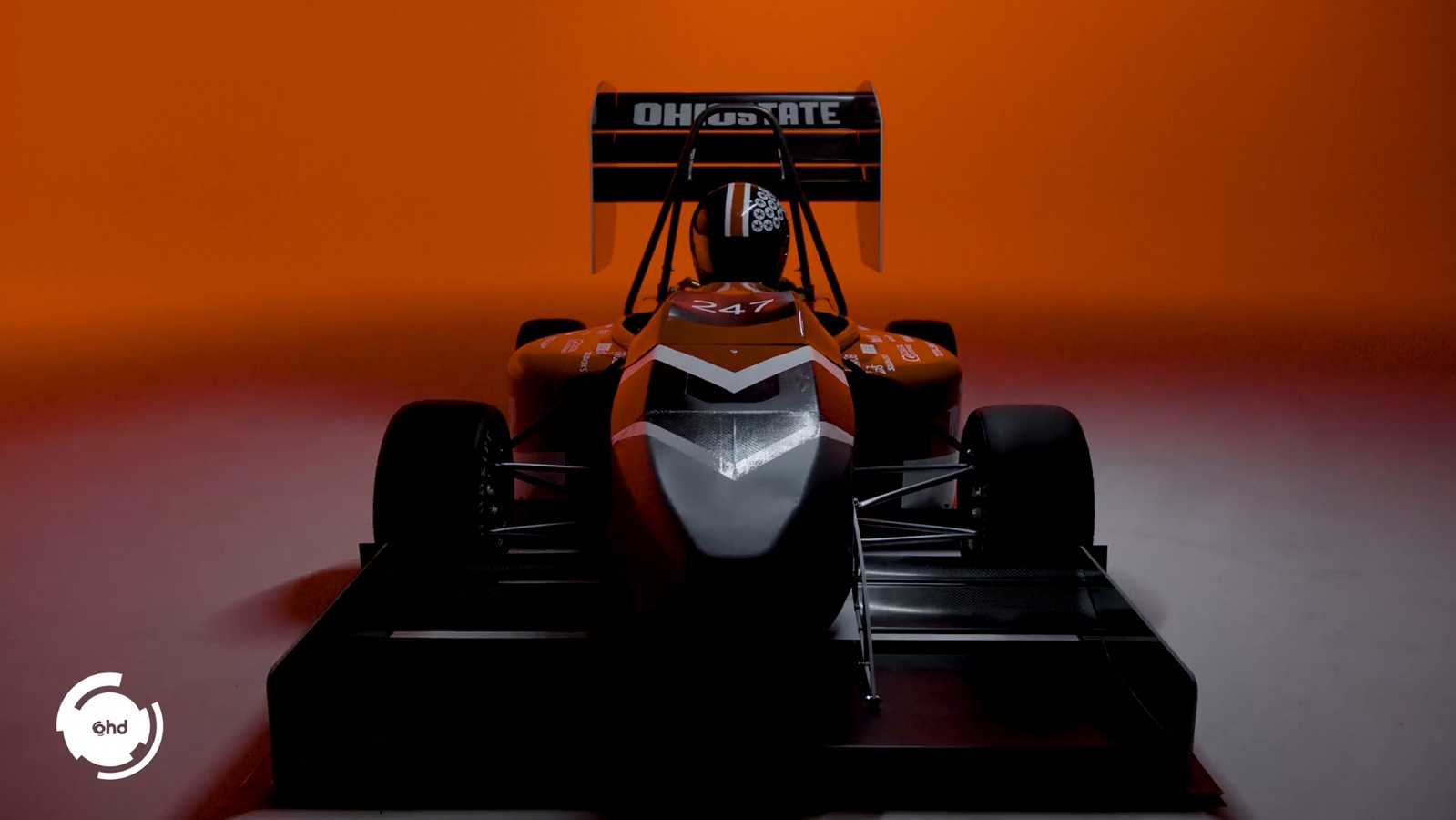 The Formula Buckeyes car seen head-on against an orange studio background