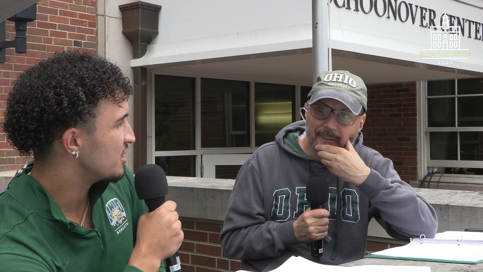 Presenters hosting the Ohio University homecoming parade broadcast