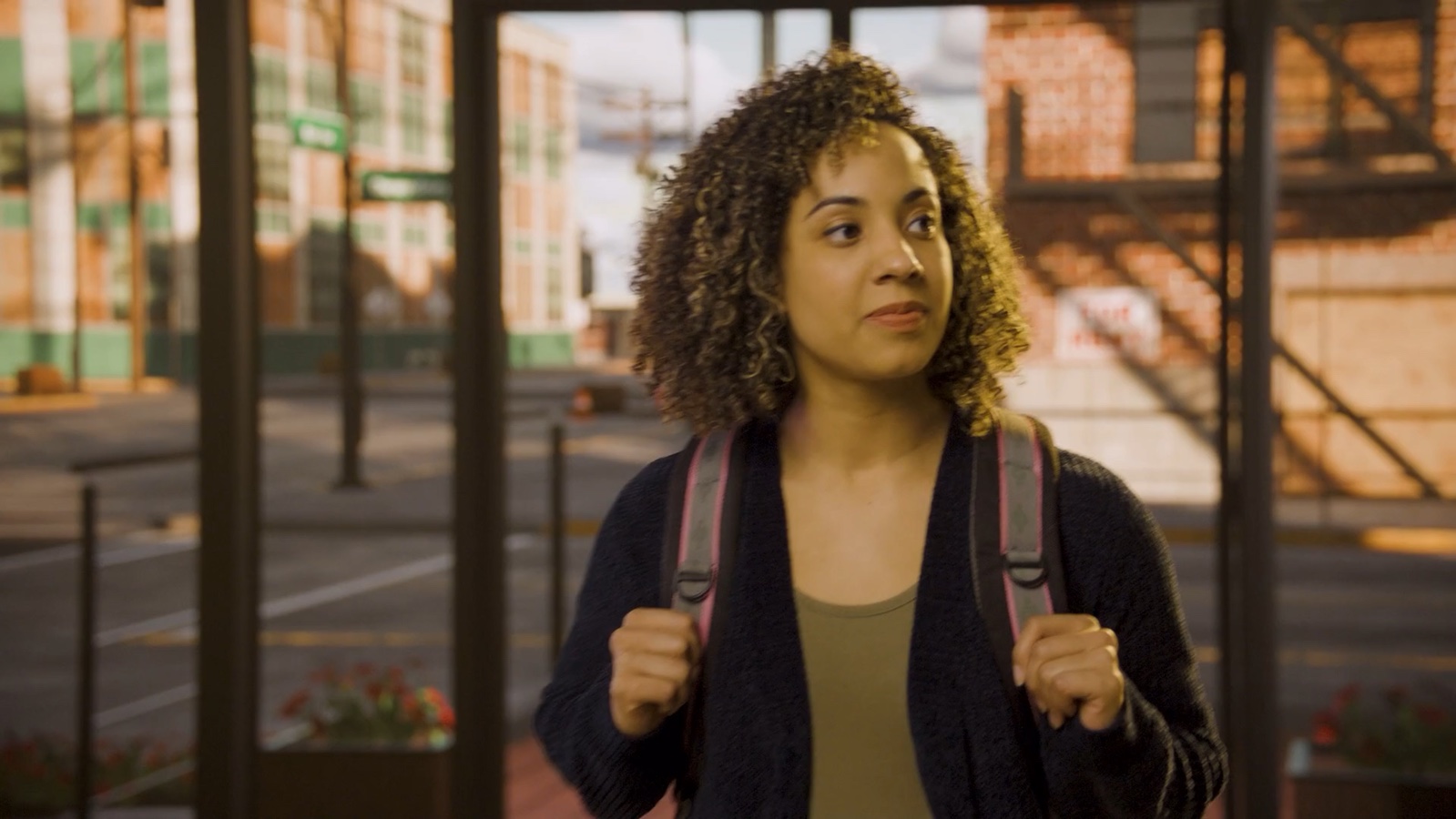 A student walking through a city in Lumen’s Rise & Shine film