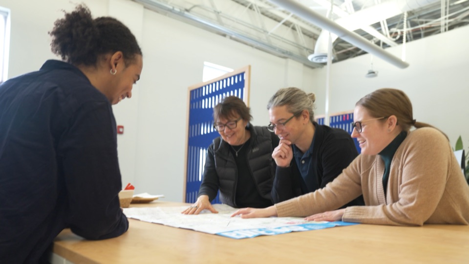 People reviewing a map together in the MORPC overview film