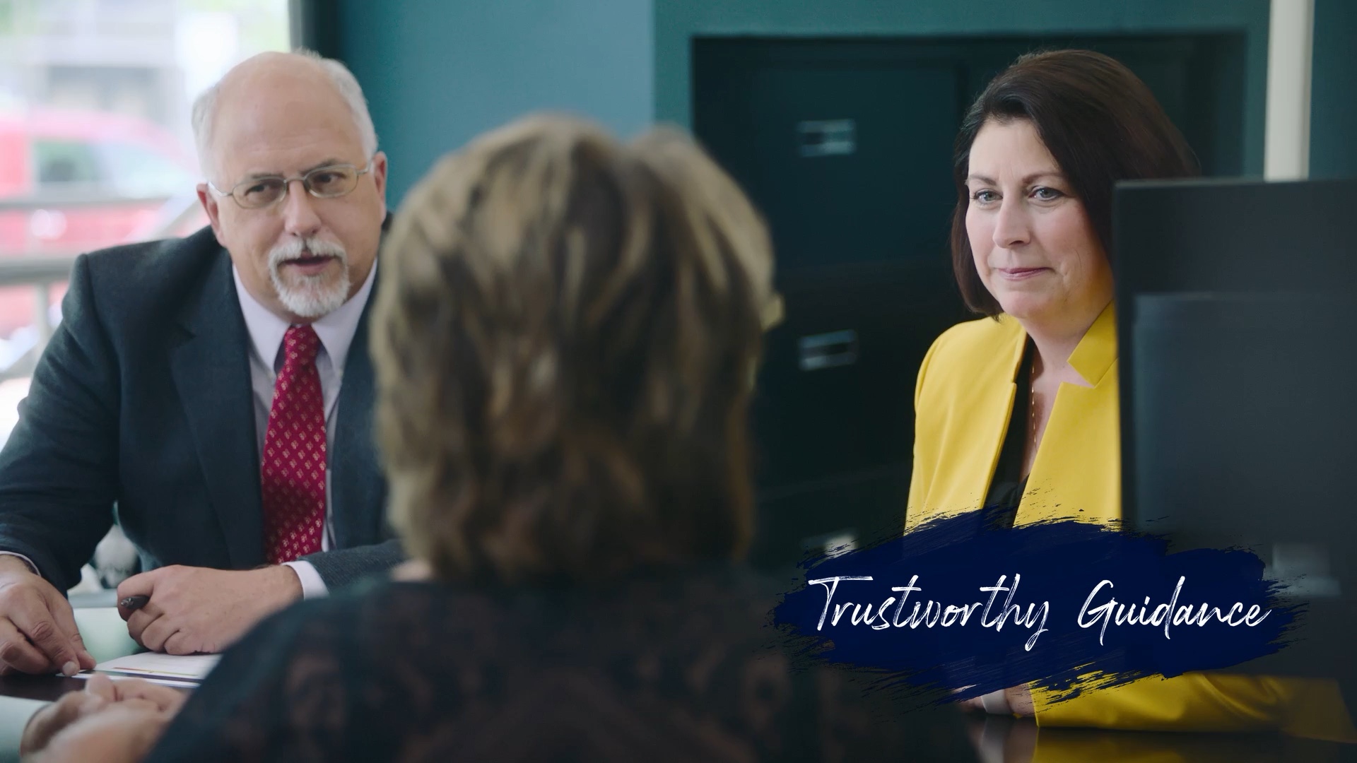Three people in a banking consultation in the Park National Bank film; original Trustworthy Guidance graphic retained