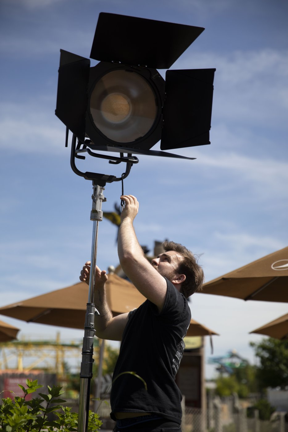 Crew member adjusting an exterior production light