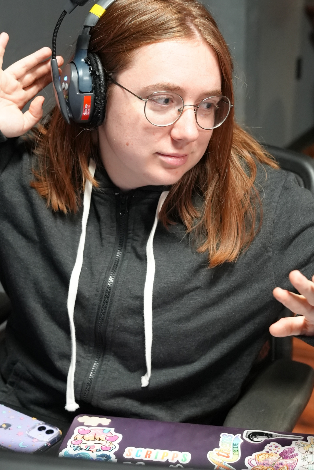 Meg Sharp wearing a headset while working on a production